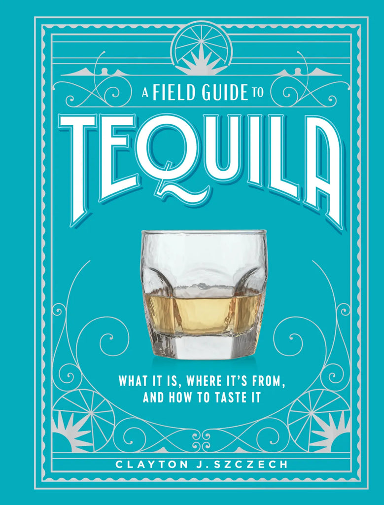 blue cover of field guide to tequila book with low ball glass of tequila