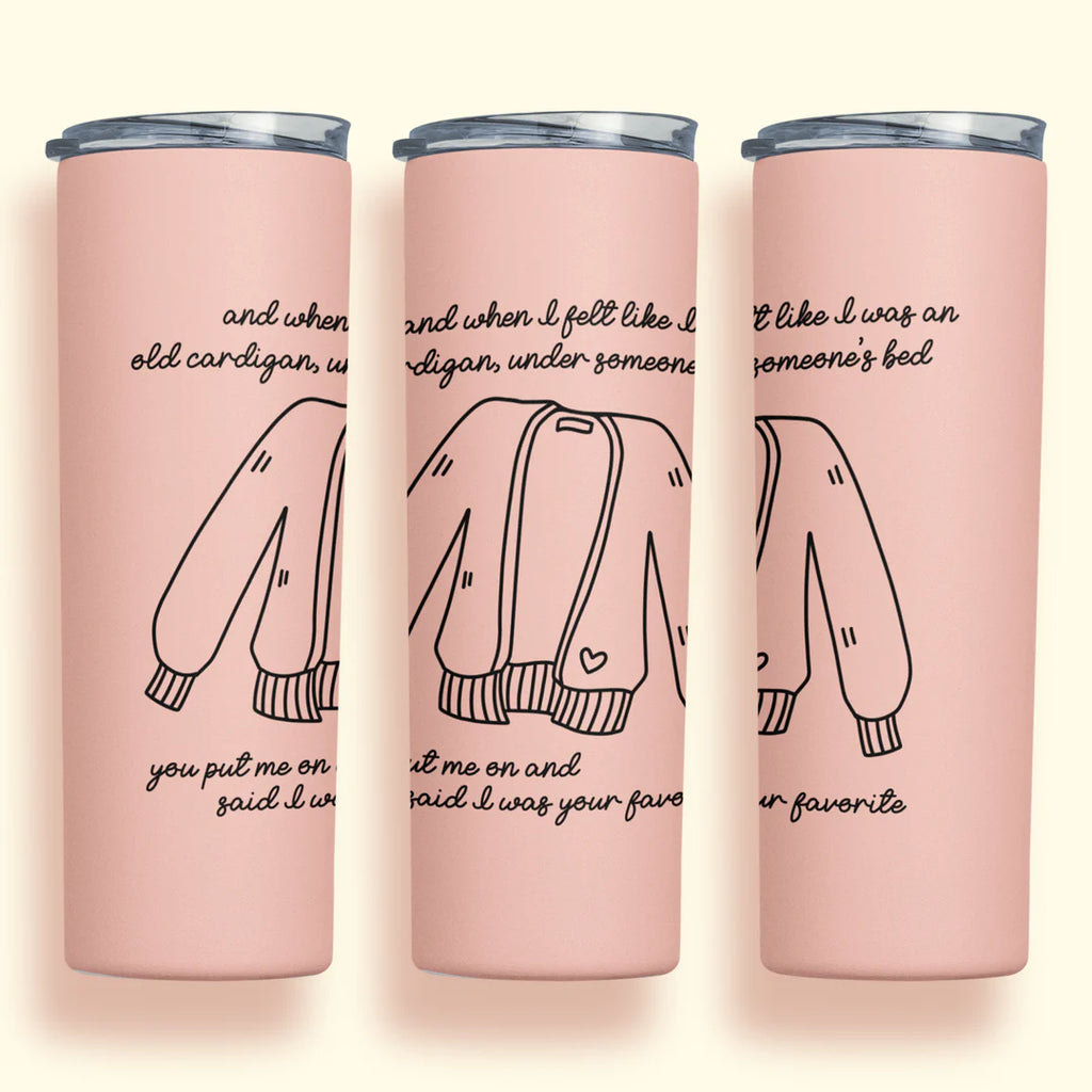 Light pink drink tumbler printed with lyrics and cardigan