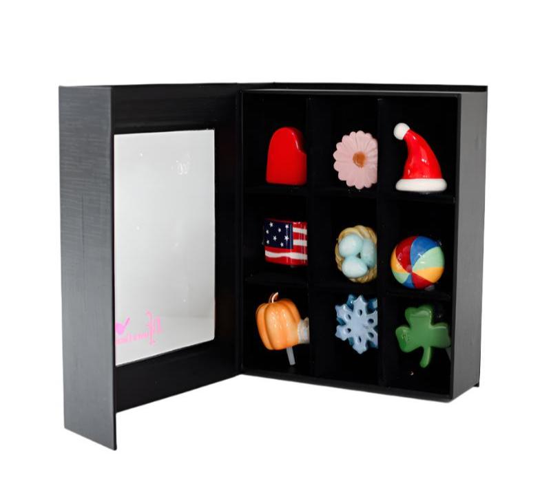 a black box filled with various ornaments including a santa hat