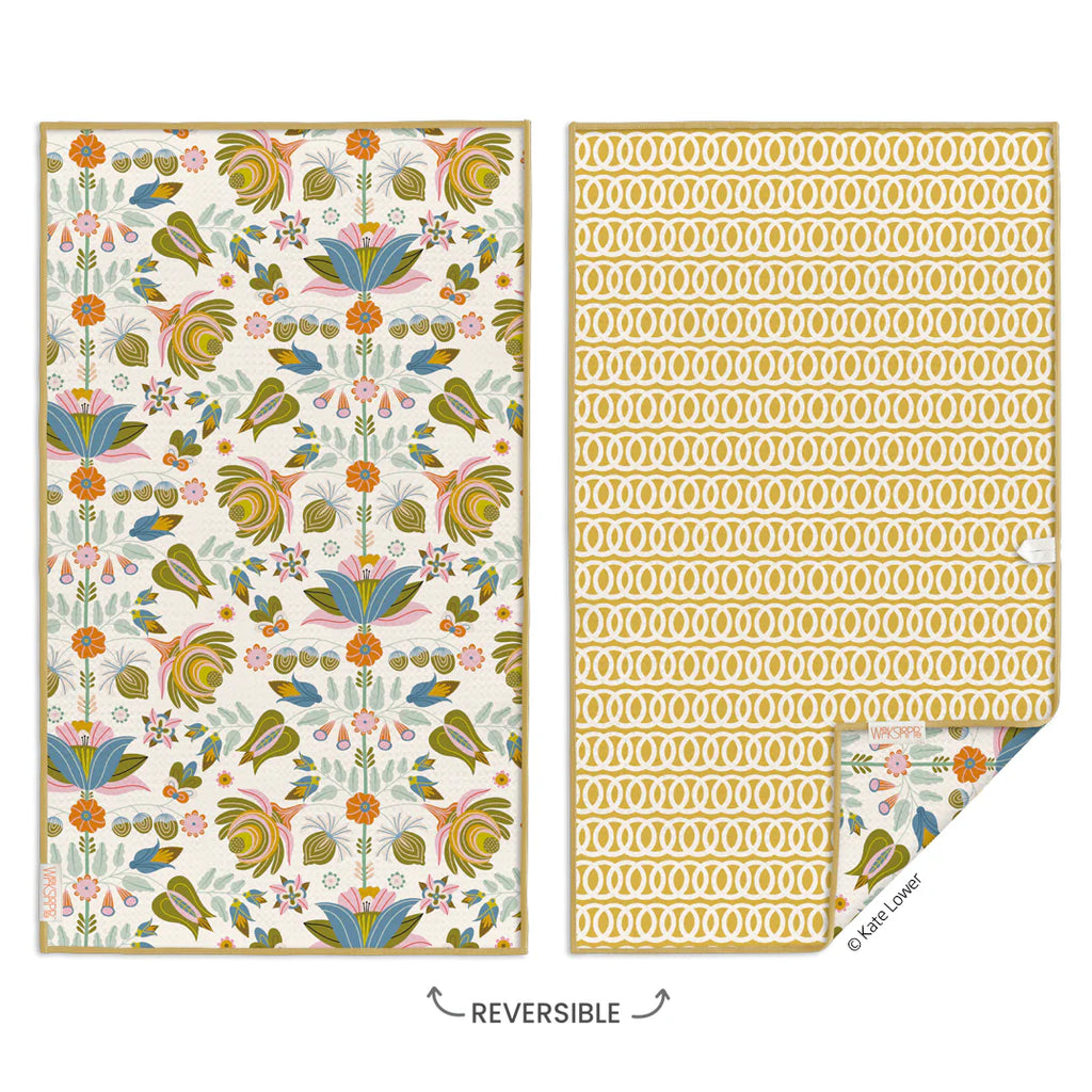 a reversible blanket with flowers and birds on it