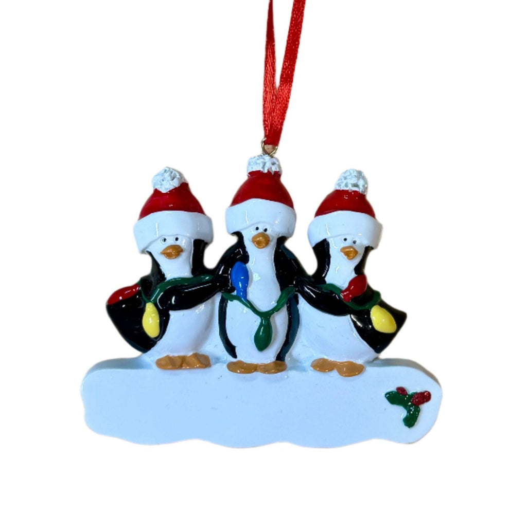 three penguins wearing santa hats are holding christmas lights
