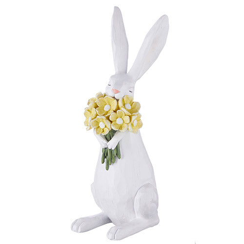 bunny figurine holding a bouquet of yellow flowers