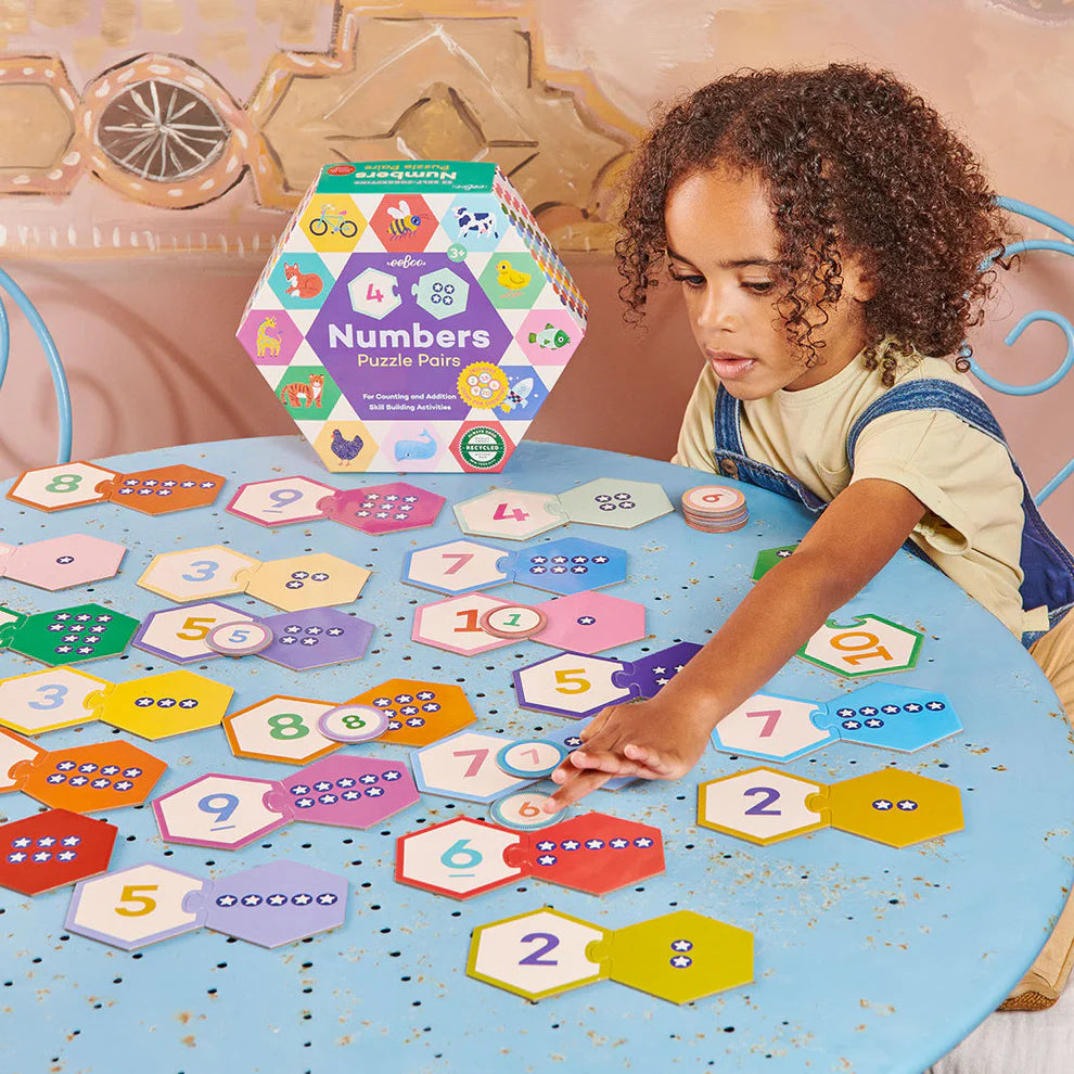 a child is playing with numbers puzzle pairs