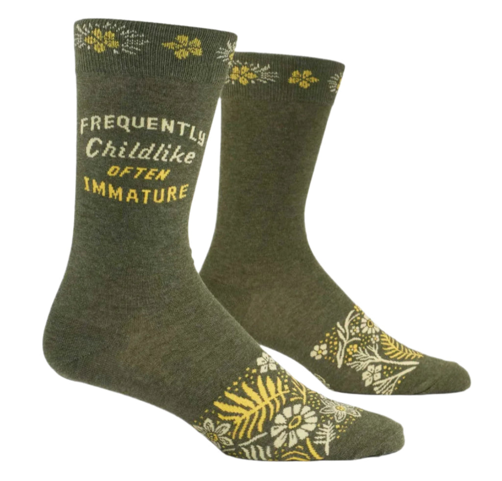 a pair of green socks that say frequently childlike often immature