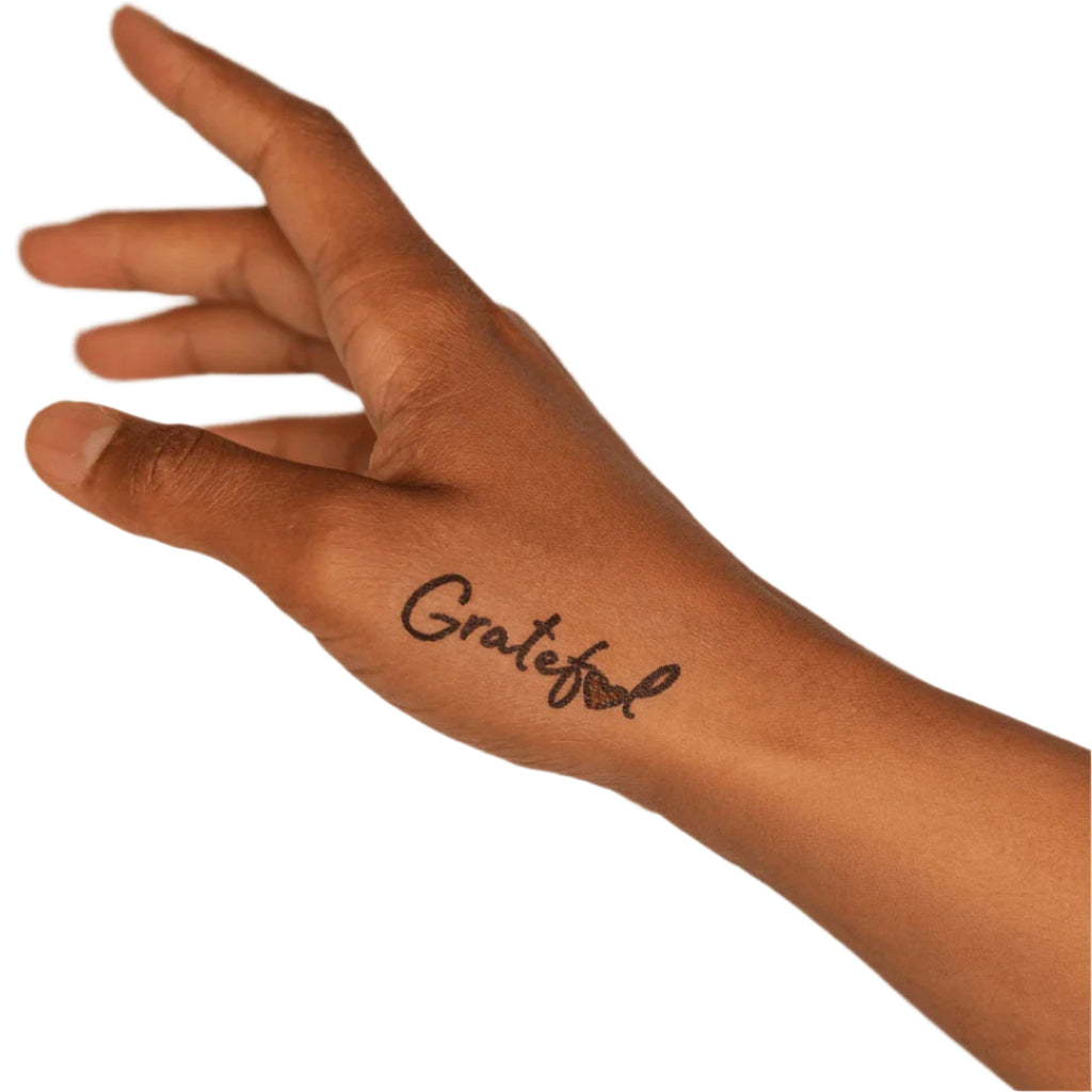 a hand with a grateful tattoo on it