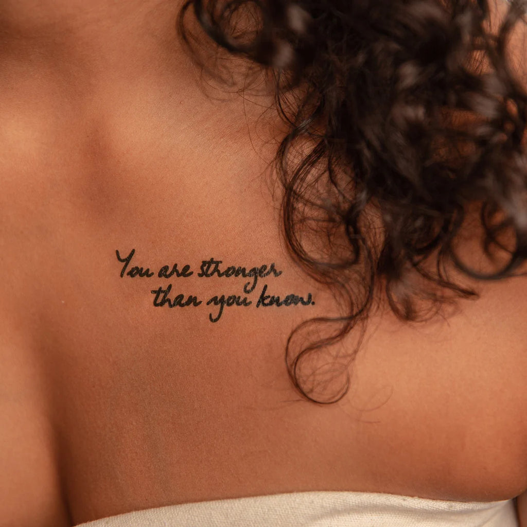a woman has a tattoo on her chest that says you are stronger than you know